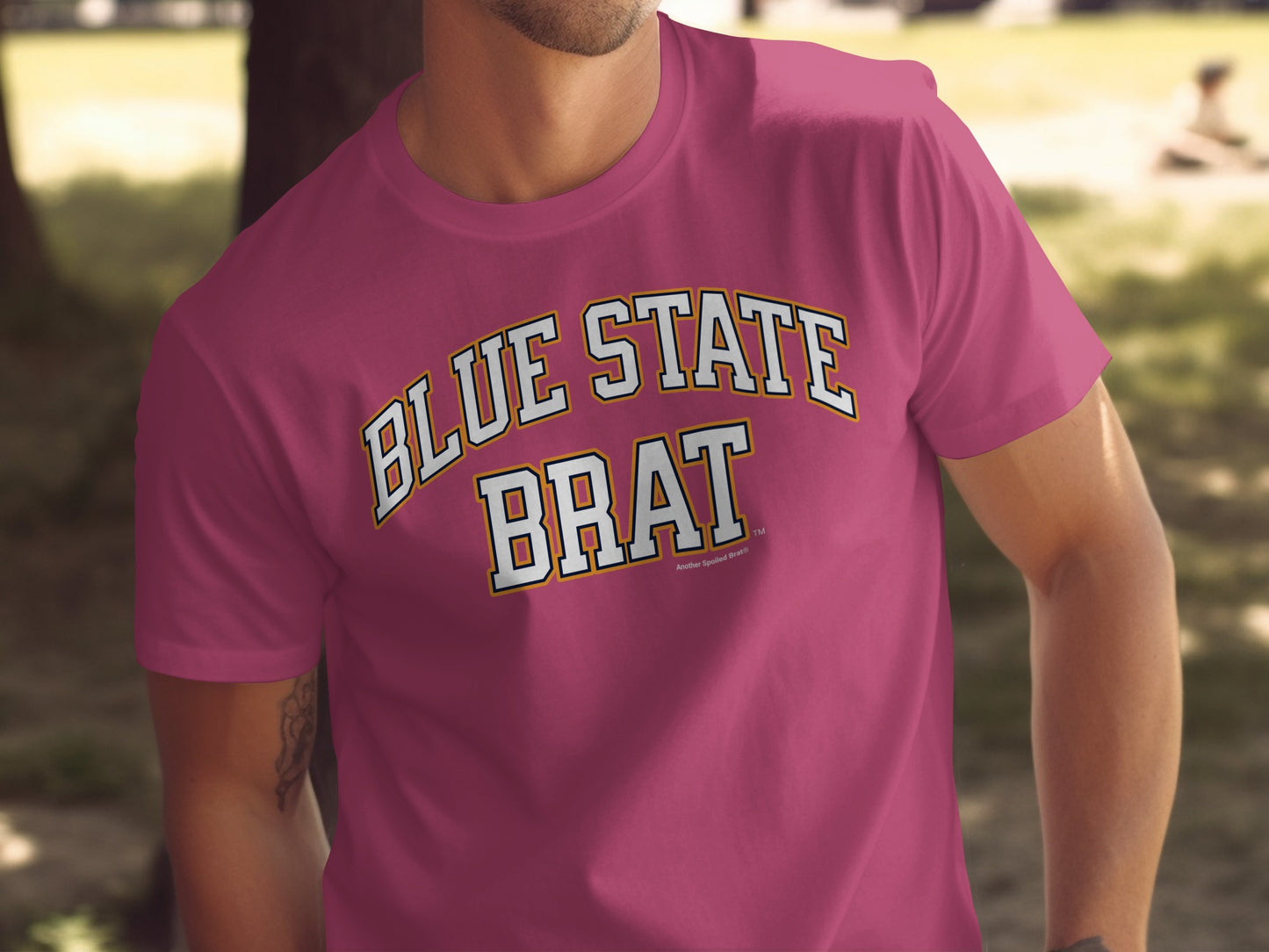 Pink t-shirt with "BLUE STATE BRAT" text in collegiate font.