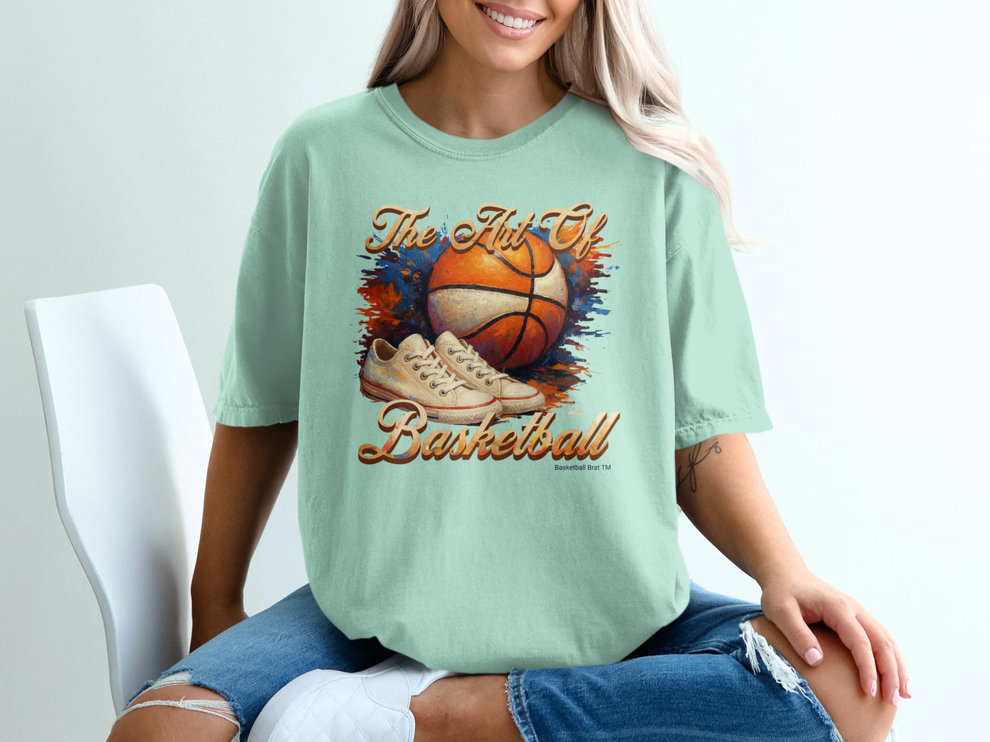 Light blue t-shirt with orange basketball and sneaker graphic.