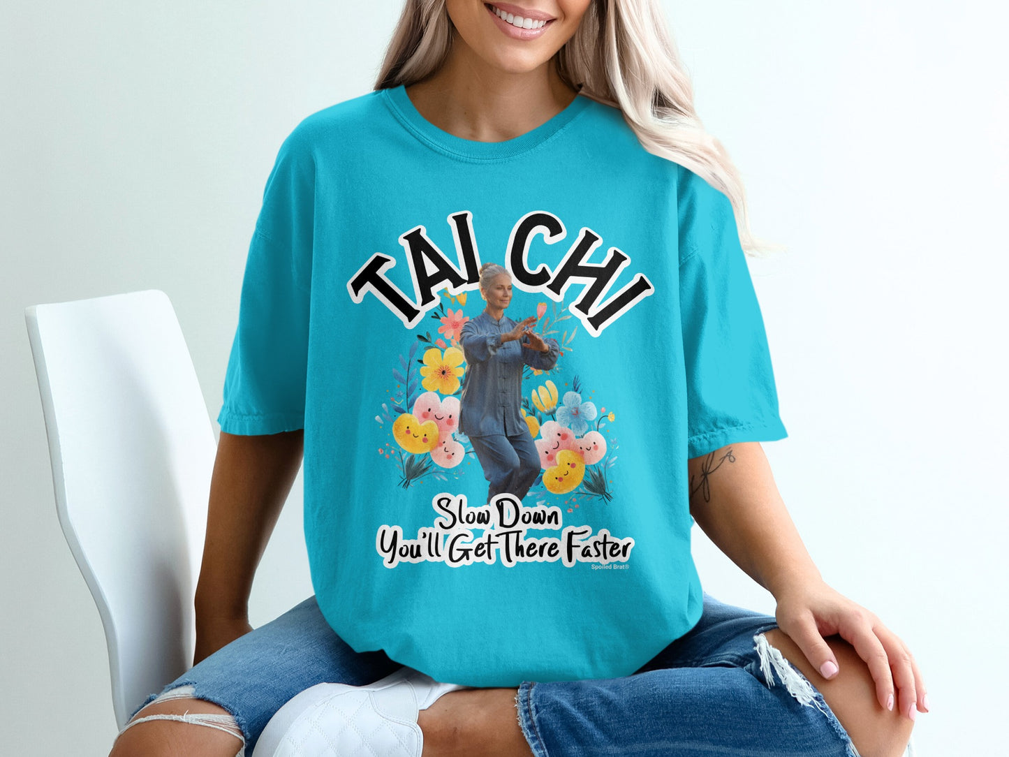 Teal t-shirt with "Tai Chi Slow Down You'll Get There Faster" and floral graphic.