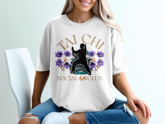 White t-shirt with "Tai Chi" and lotus flowers design, featuring a figure in a martial arts pose.