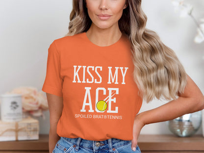 Orange t-shirt with "Kiss My Ace" and a tennis ball.