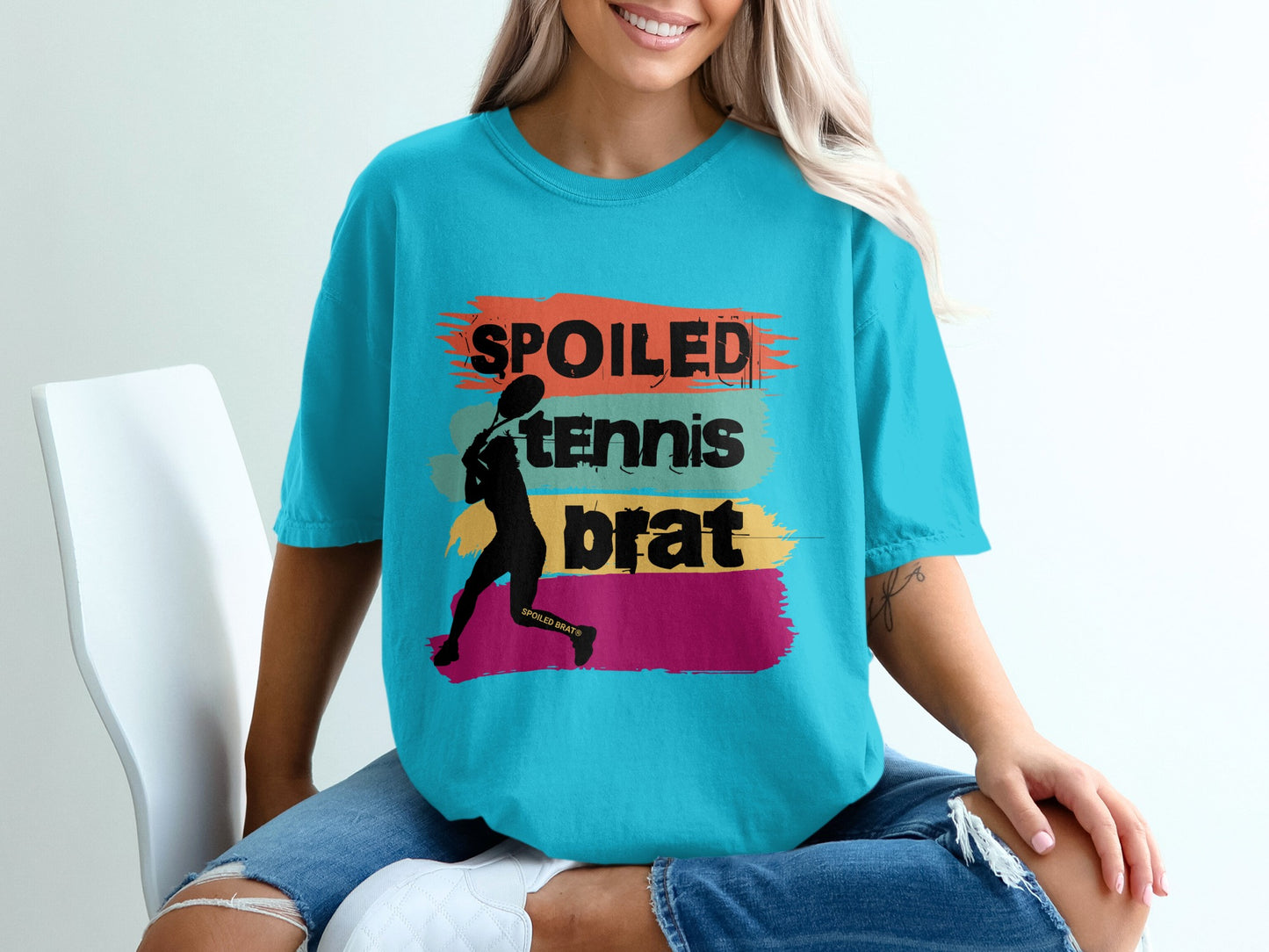Turquoise t-shirt with "spoiled tennis brat" text and tennis player silhouette.
