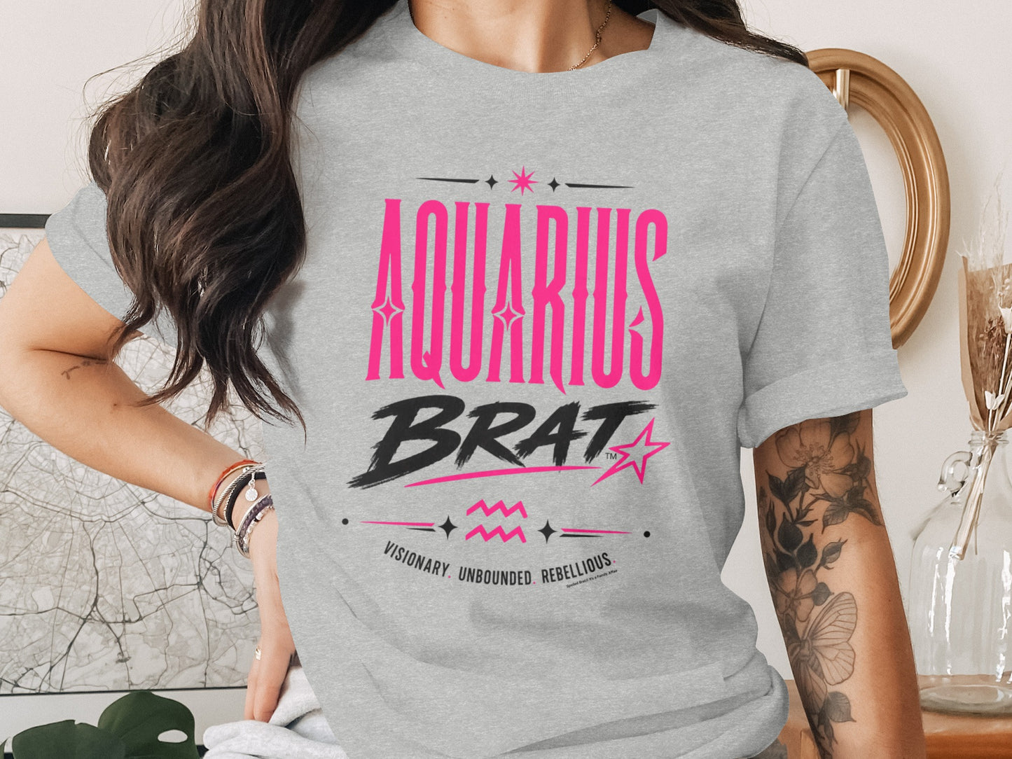 Gray t-shirt with "AQUARIUS BRAT" in pink and black, description below.