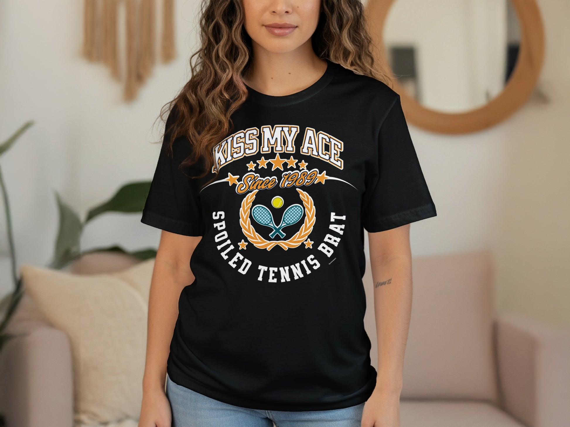 Black t-shirt with "Kiss My Ace Spoiled Tennis Brat Since 1989" text and tennis imagery.