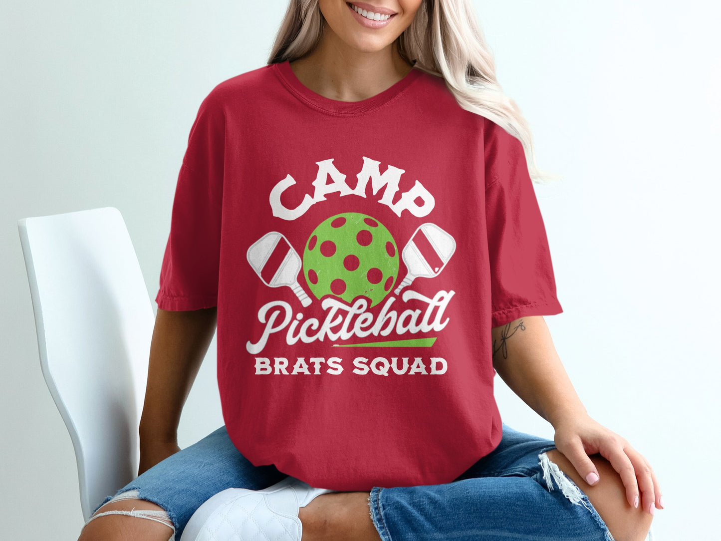 Red t-shirt with "CAMP Pickleball BRATS SQUAD" text and pickleball graphic.