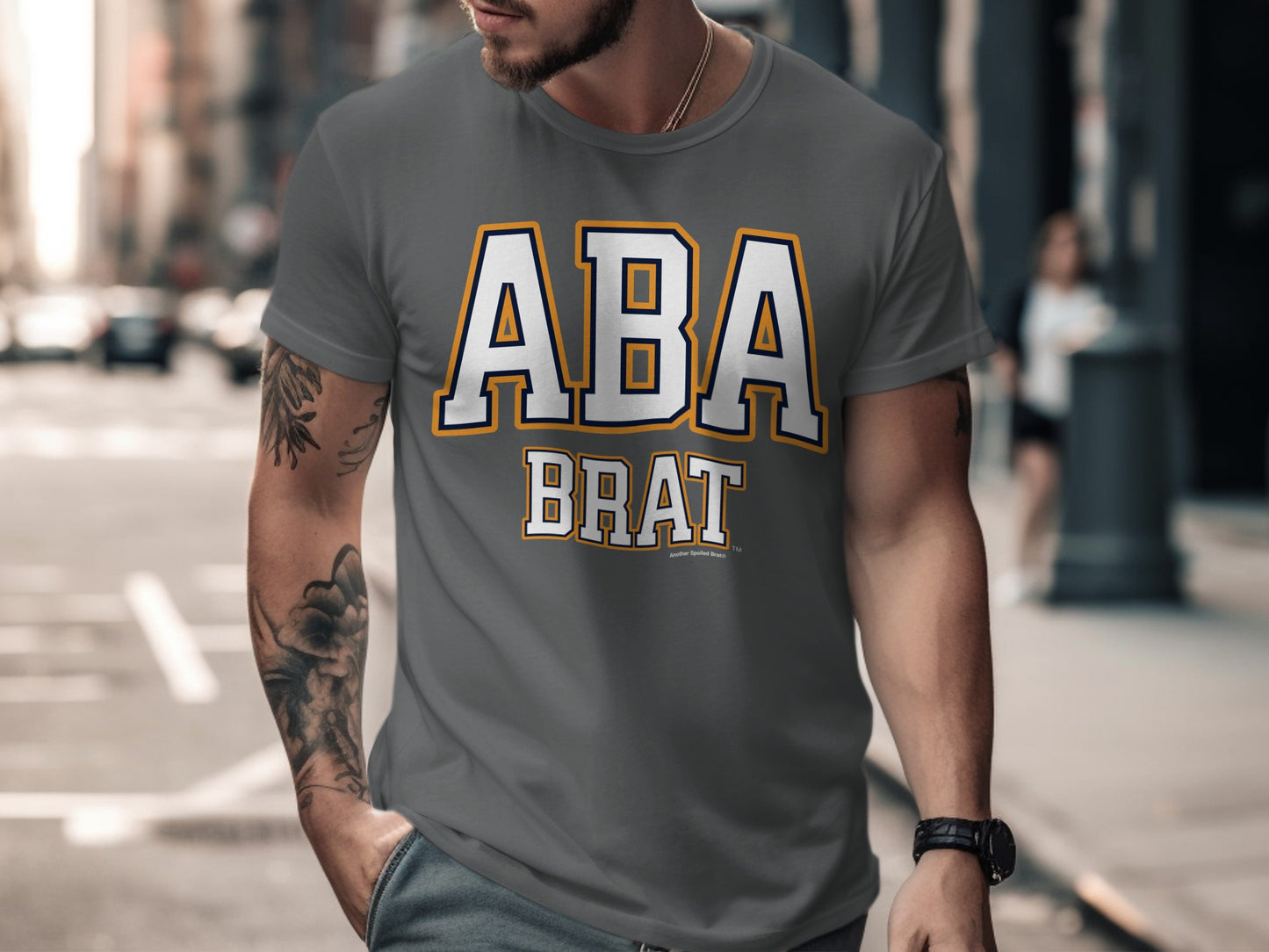 Dark grey t-shirt with white and yellow "ABA BRAT" text