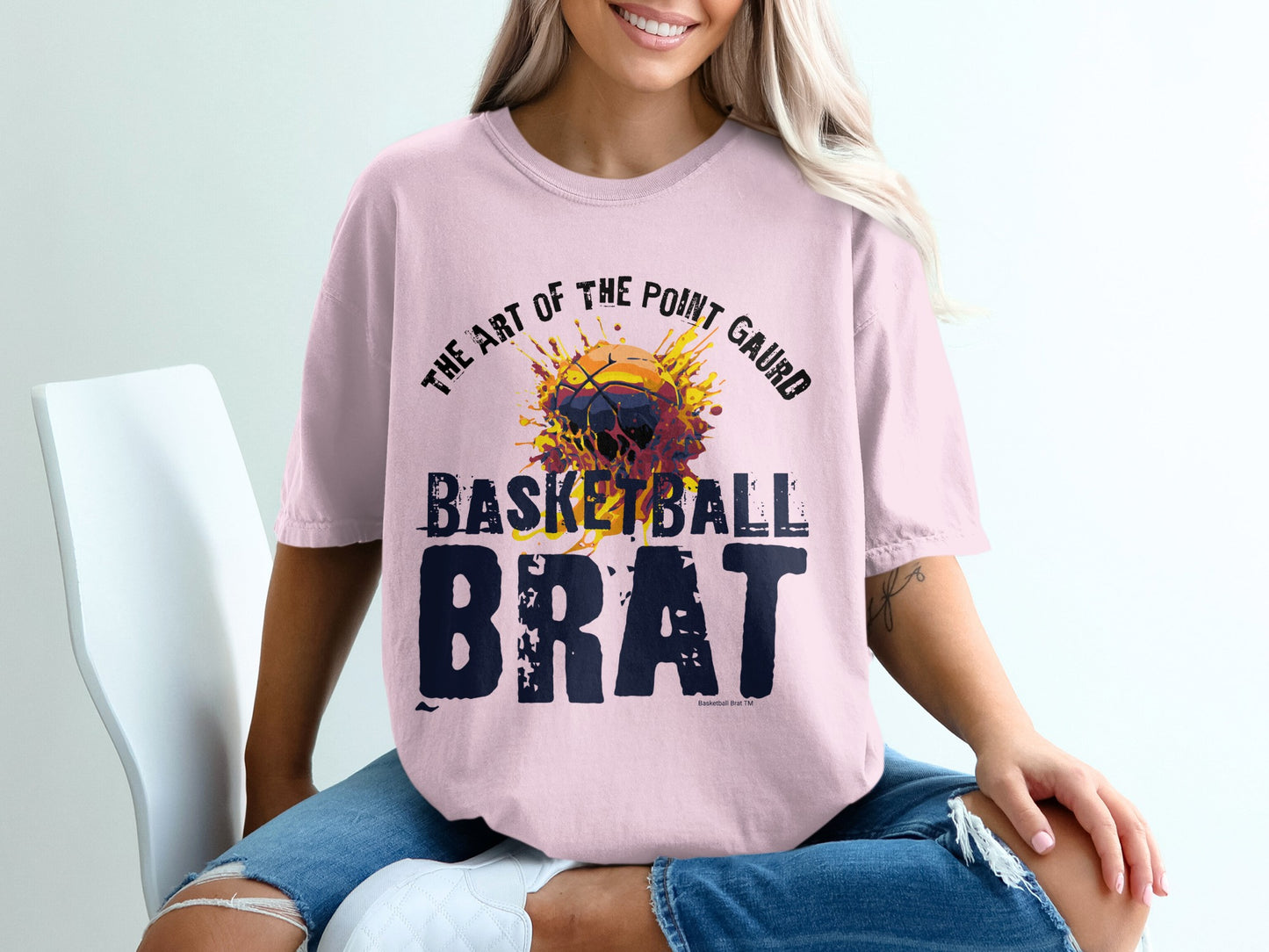 Pink t-shirt with "Basketball Brat" and artful basketball design.