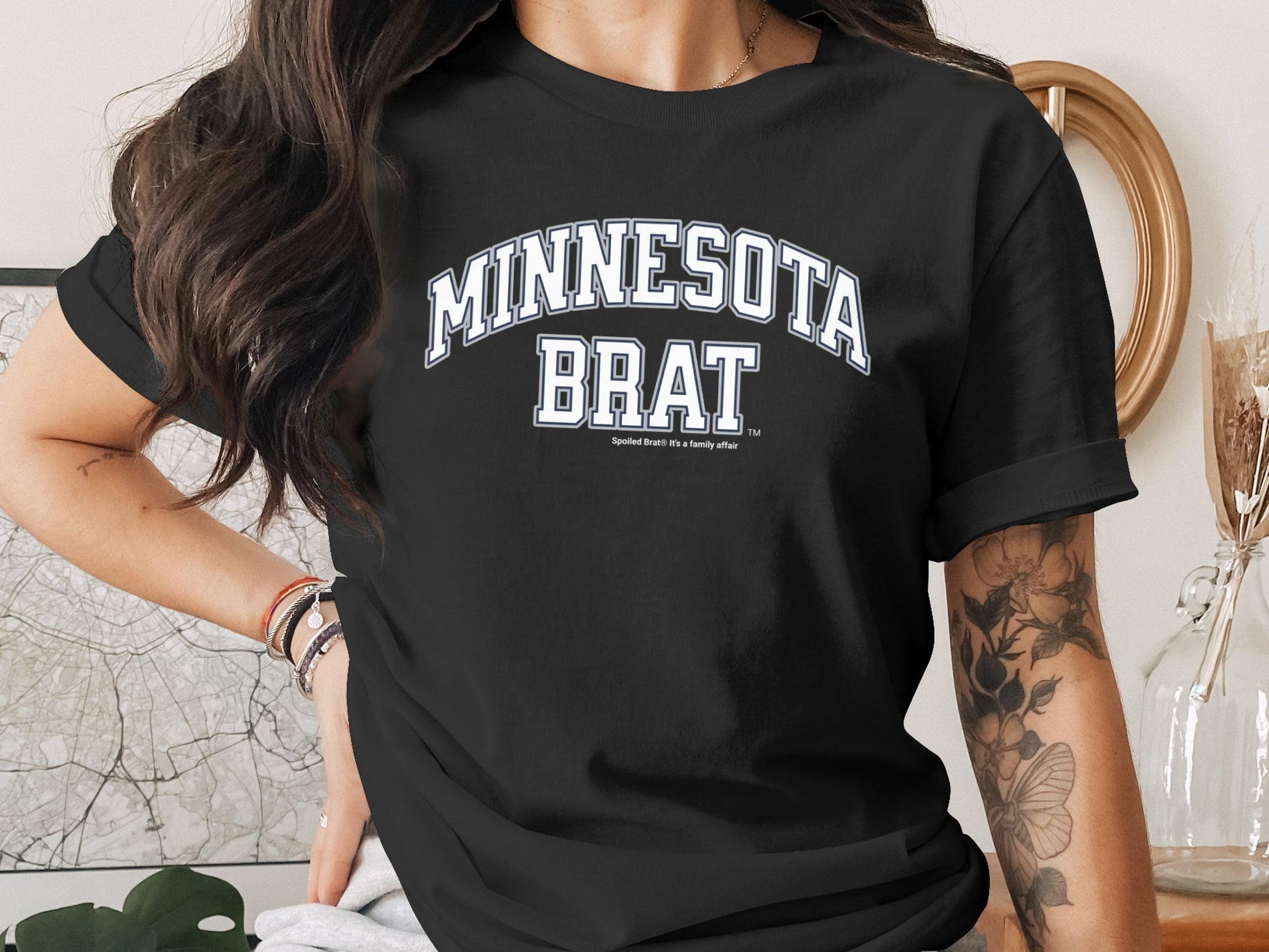 Black t-shirt with "MINNESOTA BRAT" in white collegiate lettering.