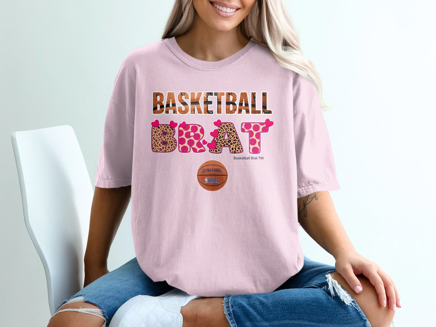 Pink t-shirt with "BASKETBALL BRAT" text and leopard print letters.