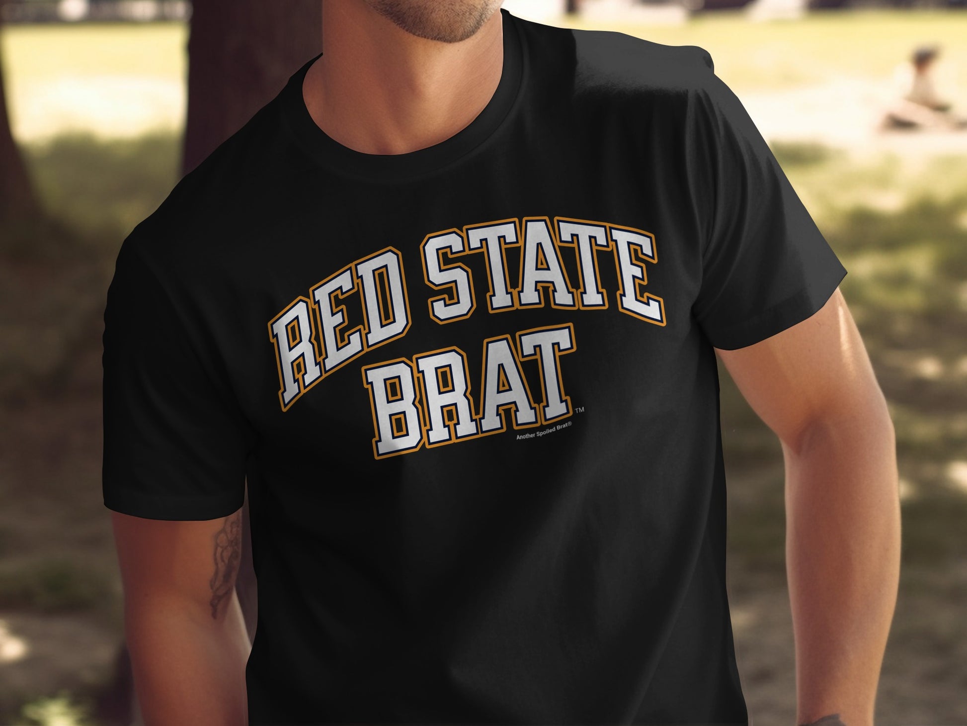 Black t-shirt with "RED STATE BRAT"text in white and yellow.
