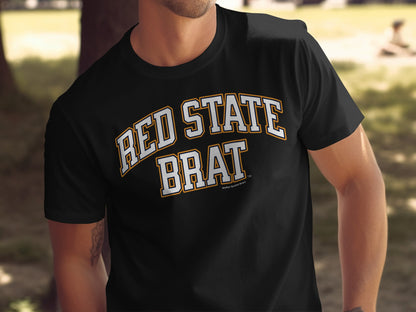 Black t-shirt with "RED STATE BRAT"text in white and yellow.