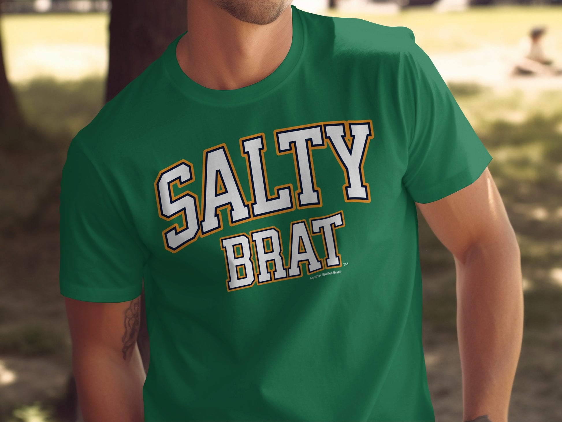 Green t-shirt with "SALTY BRAT" text in white with orange and blue outline.