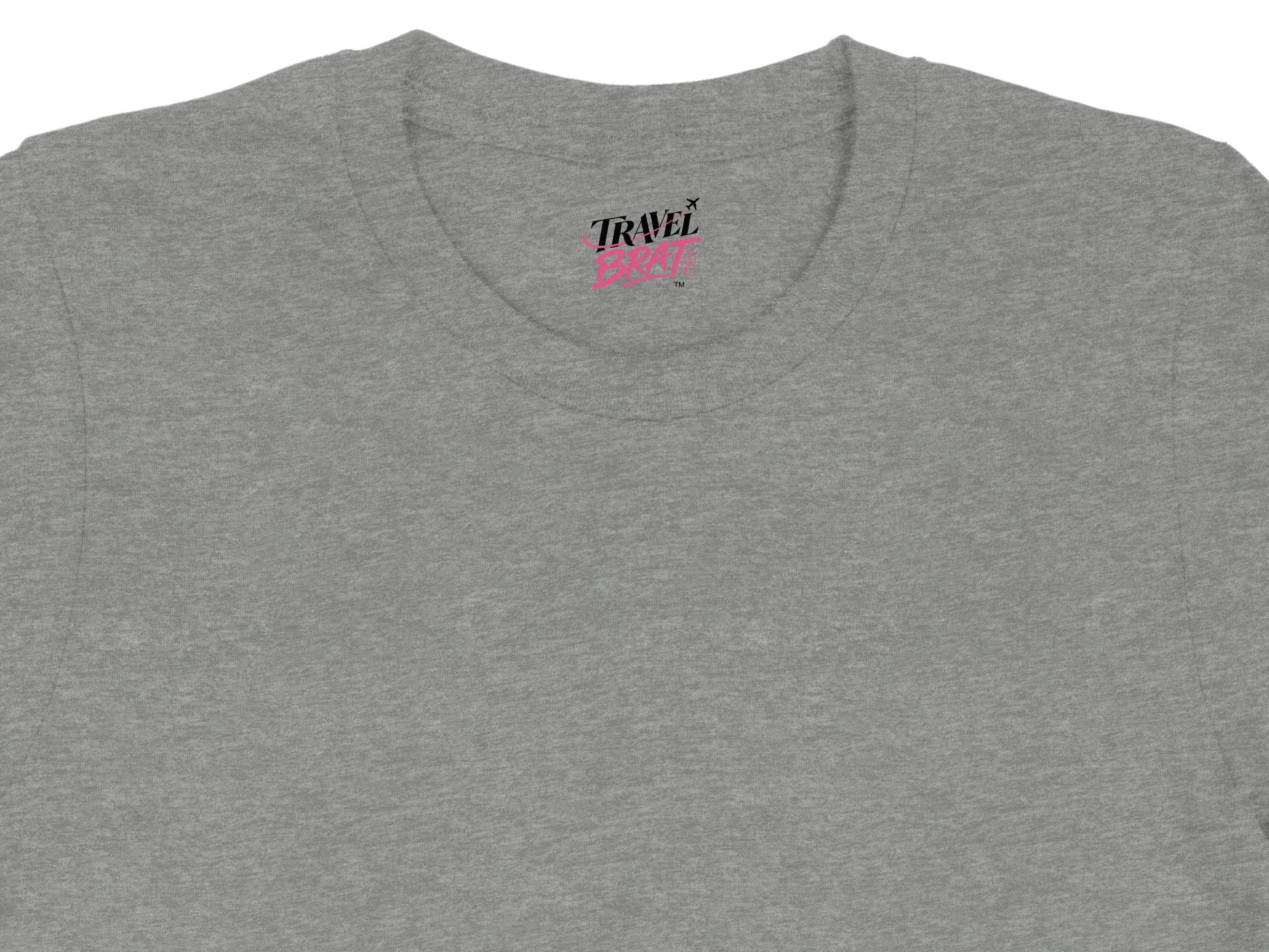 Grey t-shirt with "TRAVEL BRAT" text and airplane graphic.