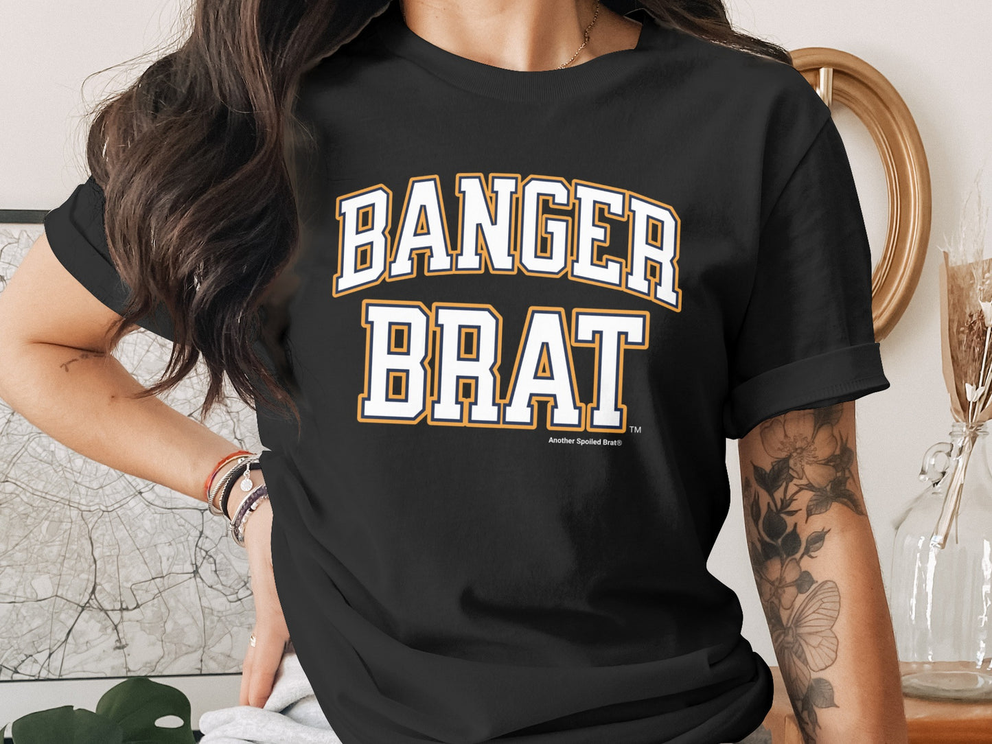Black t-shirt with "BANGER BRAT" in white and gold collegiate lettering.