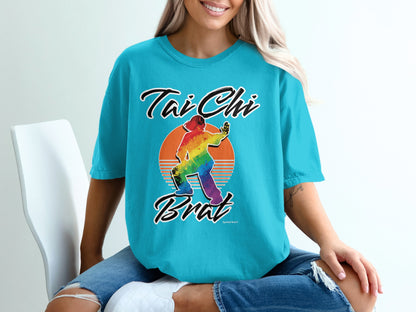 Turquoise t-shirt with "Tai Chi Brat" text and rainbow sunset graphic.