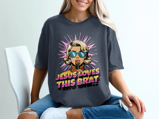 Woman wearing a dark t-shirt with "JESUS LOVES THIS BRAT" graphic.