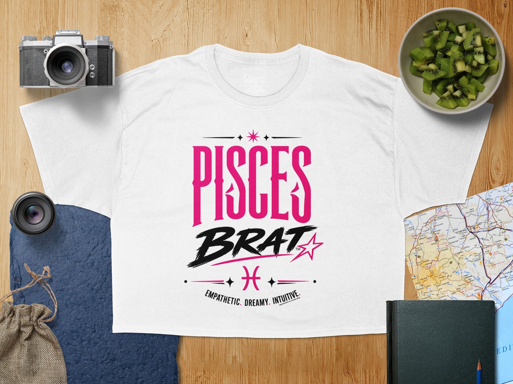 White t-shirt with "PISCES BRAT" in pink and black text.