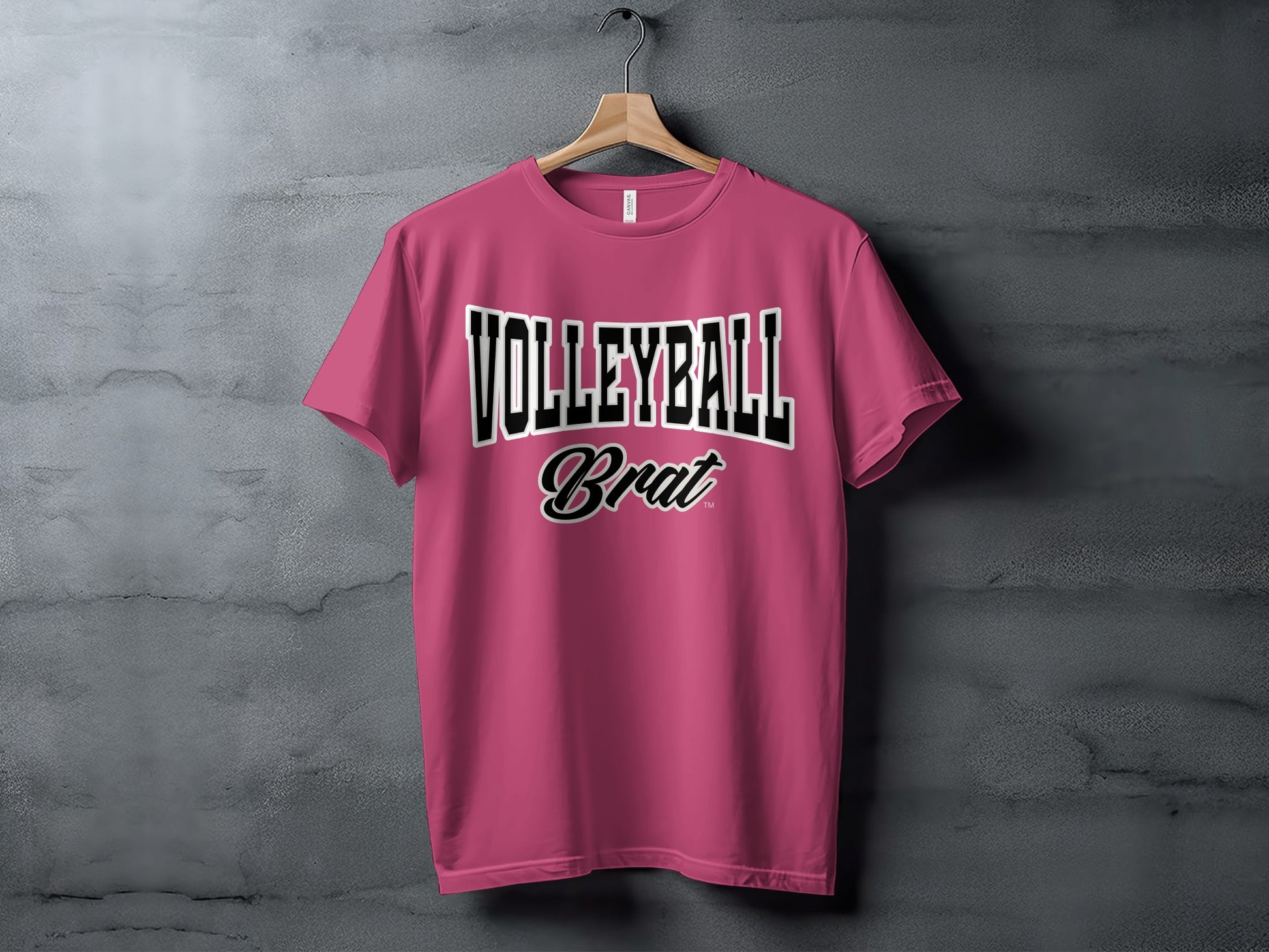 Pink t-shirt with "VOLLEYBALL Brat" text on a grey background.