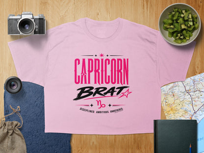 Pink t-shirt with "Capricorn Brat" text and Capricorn symbol.