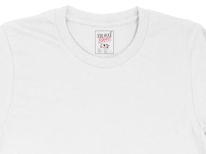 White t-shirt with "TRAVEL BRATS" label showing destinations.