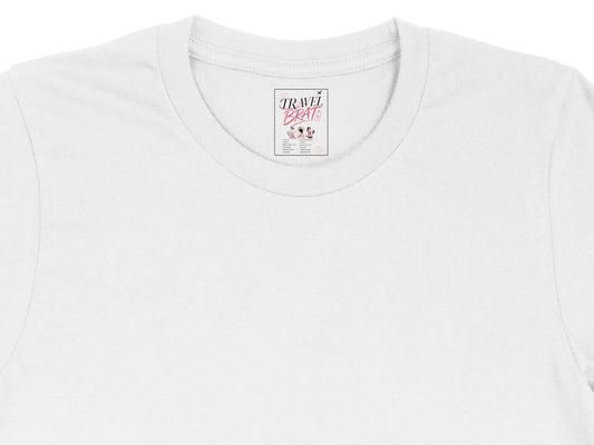 White t-shirt with "TRAVEL BRATS" label showing destinations.
