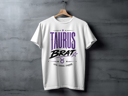 White t-shirt with purple "TAURUS BRAT" text, zodiac symbol, and traits.