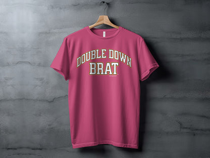 Pink t-shirt with "DOUBLE DOWN BRAT" text in white and gold lettering.