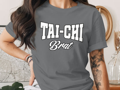 T-shirt with bold white "TAI-CHI" and script "Brat" lettering.