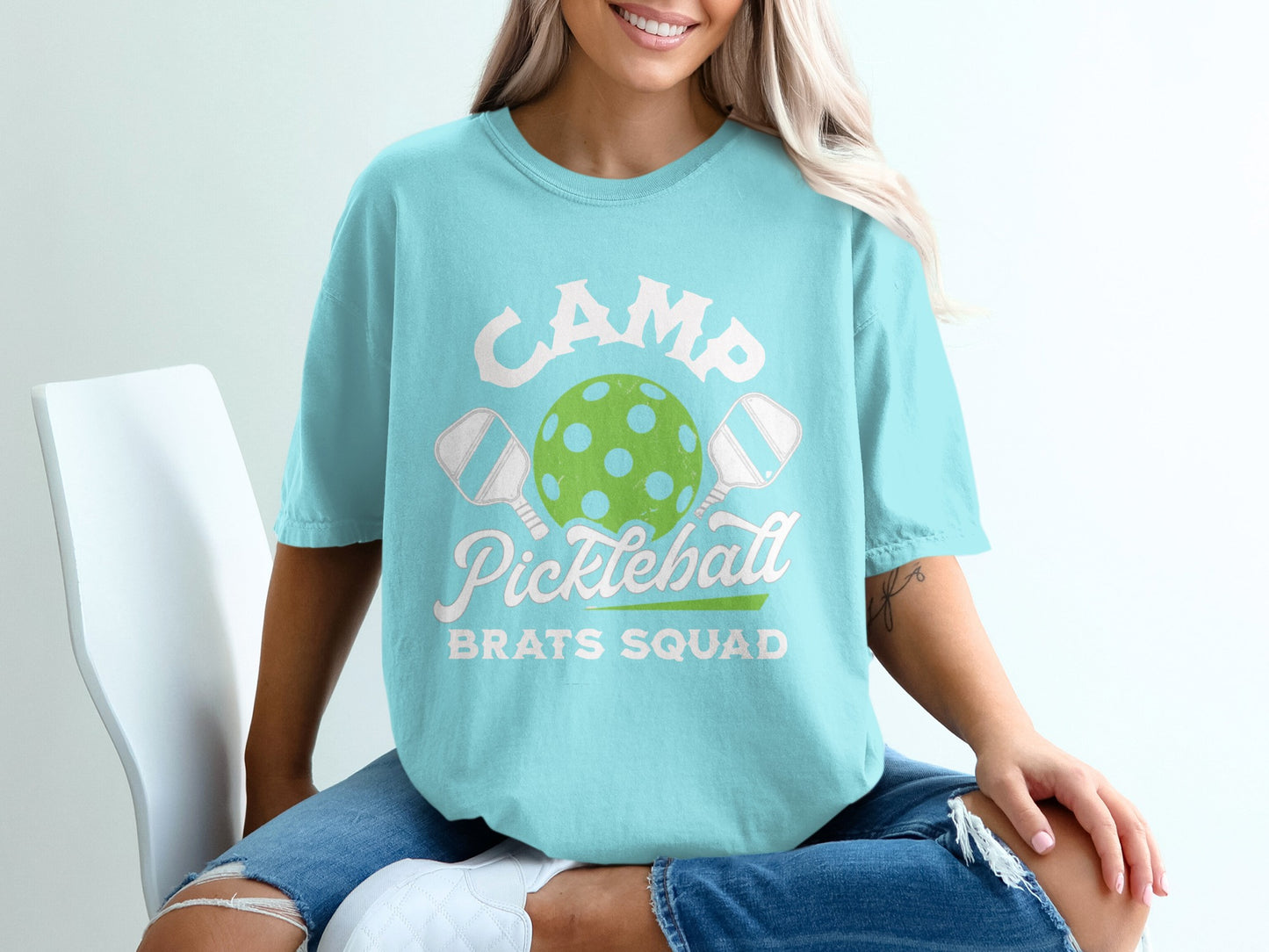 Teal t-shirt with "Camp Pickleball Brats Squad" graphic and pickleball illustration.