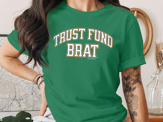 Green t-shirt with "TRUST FUND BRAT" in collegiate font and "Another Spoiled Brat" below.