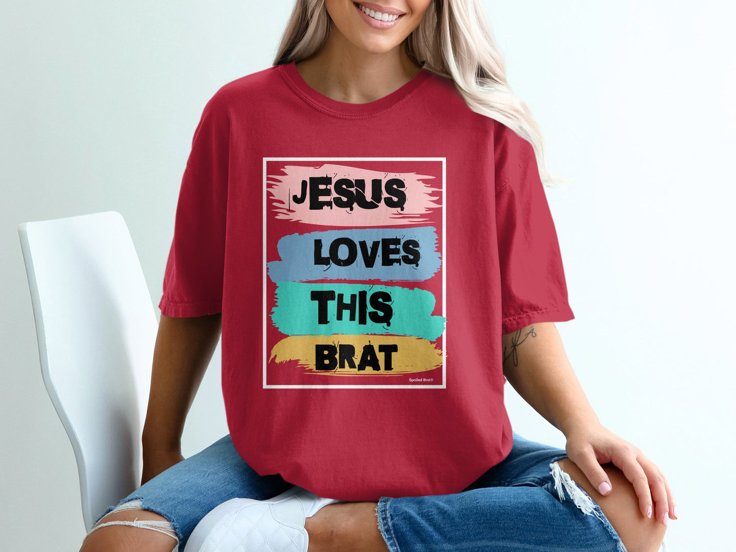 Red t-shirt with "JESUS LOVES THIS BRAT" in distressed text.