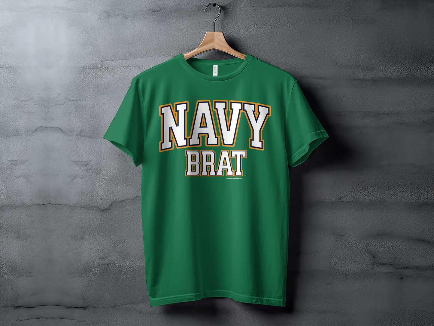 Green t-shirt with white and gold text reading "NAVY BRAT" and "Another Spoiled Brat"