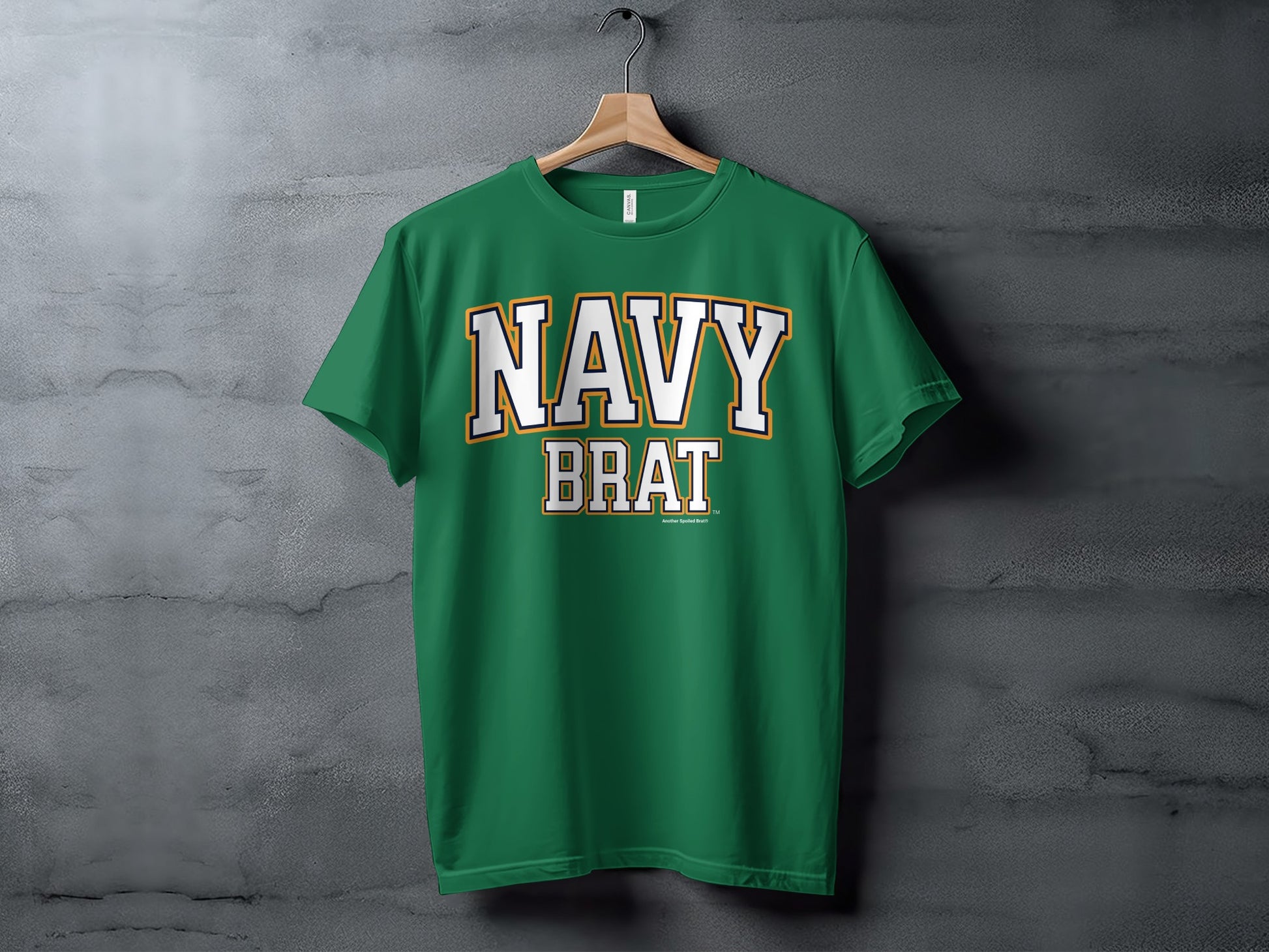 Green t-shirt with white and gold text reading "NAVY BRAT" and "Another Spoiled Brat"
