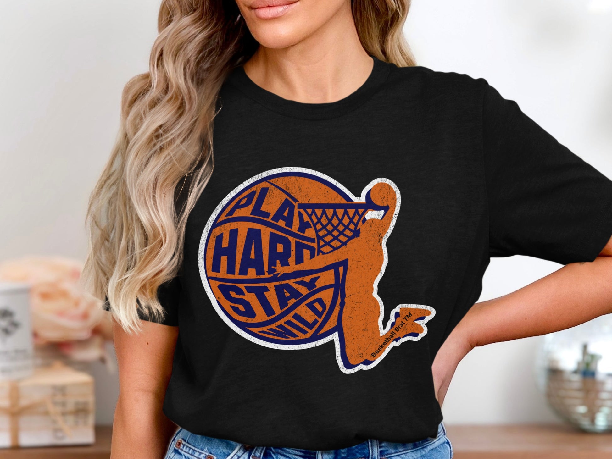 Black t-shirt with orange basketball player graphic and text.