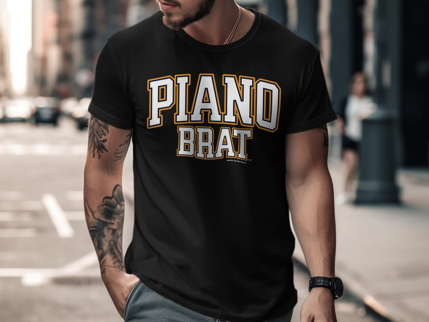 Black t-shirt with "PIANO BRAT" lettering in white and gold.