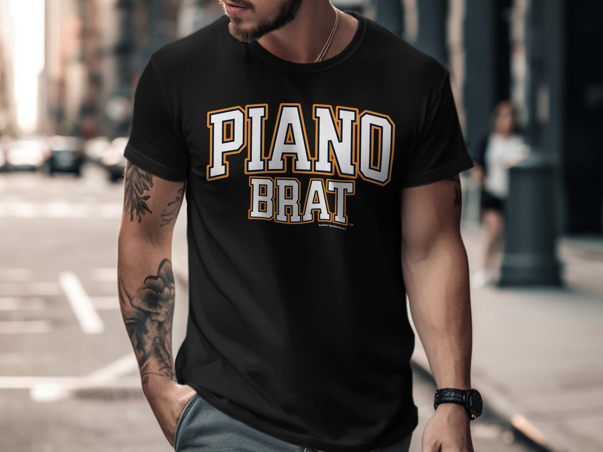 Black t-shirt with "PIANO BRAT" lettering in white and gold.