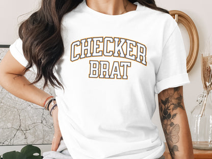 White t-shirt with "CHECKER BRAT" text in navy and gold collegiate lettering.