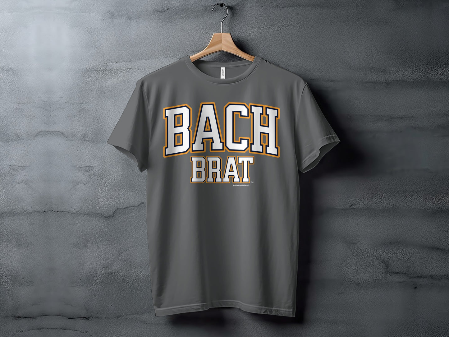 Dark grey t-shirt with white text "BACH BRAT" in collegiate style lettering.