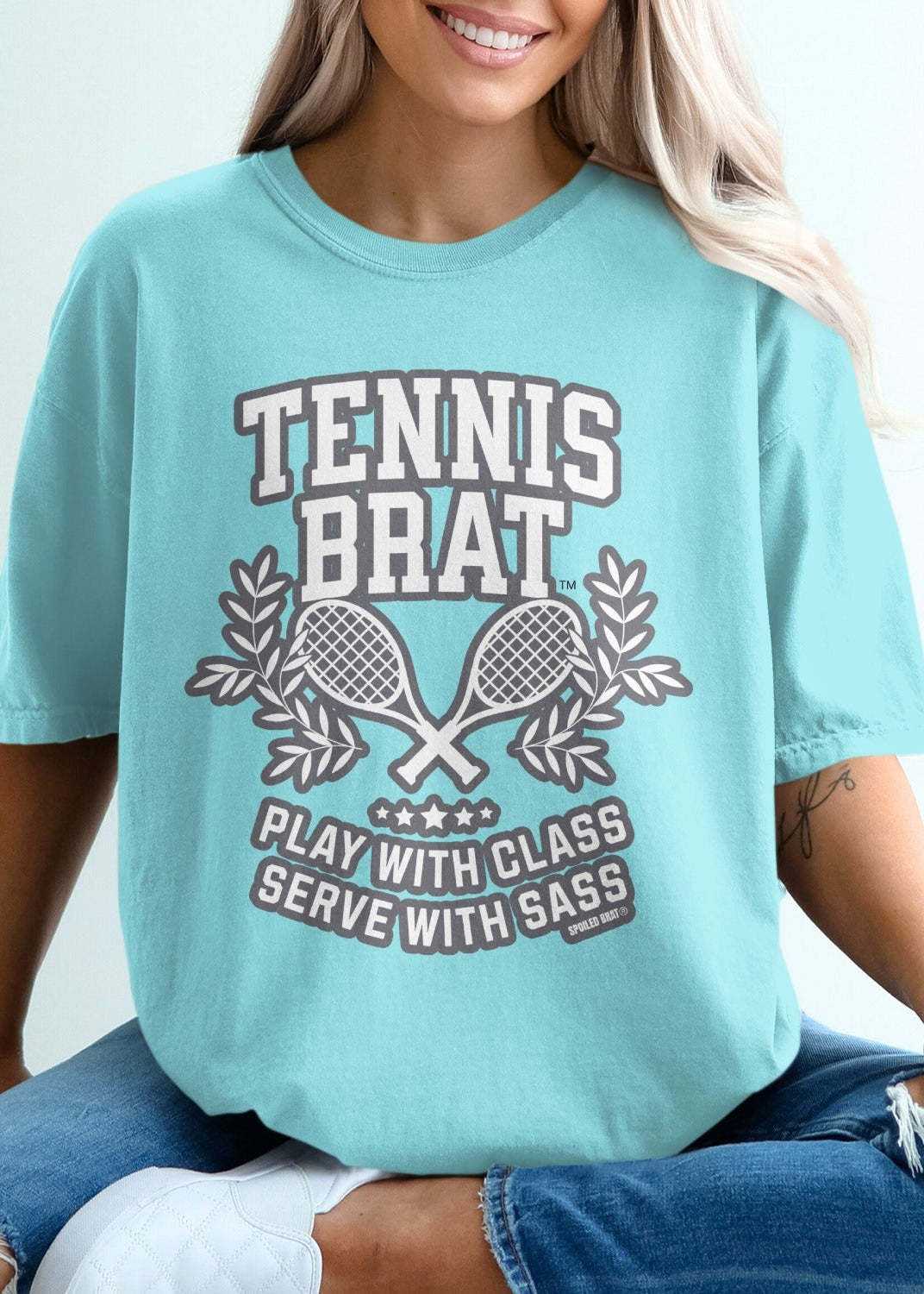 Teal t-shirt with "Tennis Brat Play With Sass" and crossed rackets.