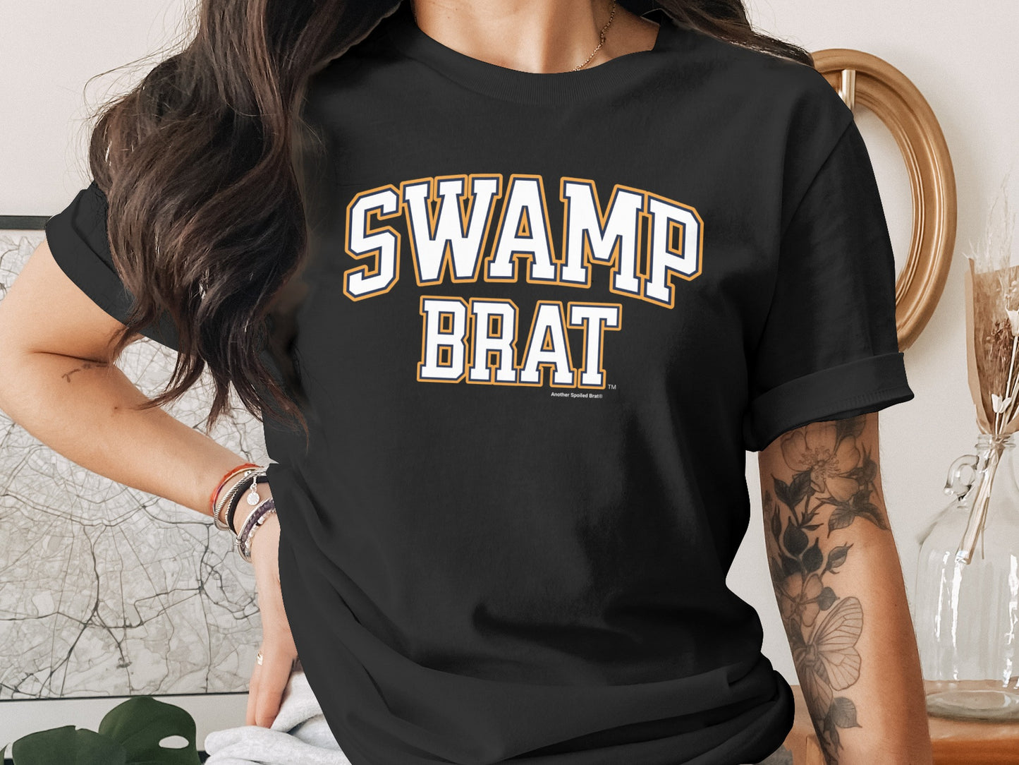 Black t-shirt with white and orange "SWAMP BRAT" text.