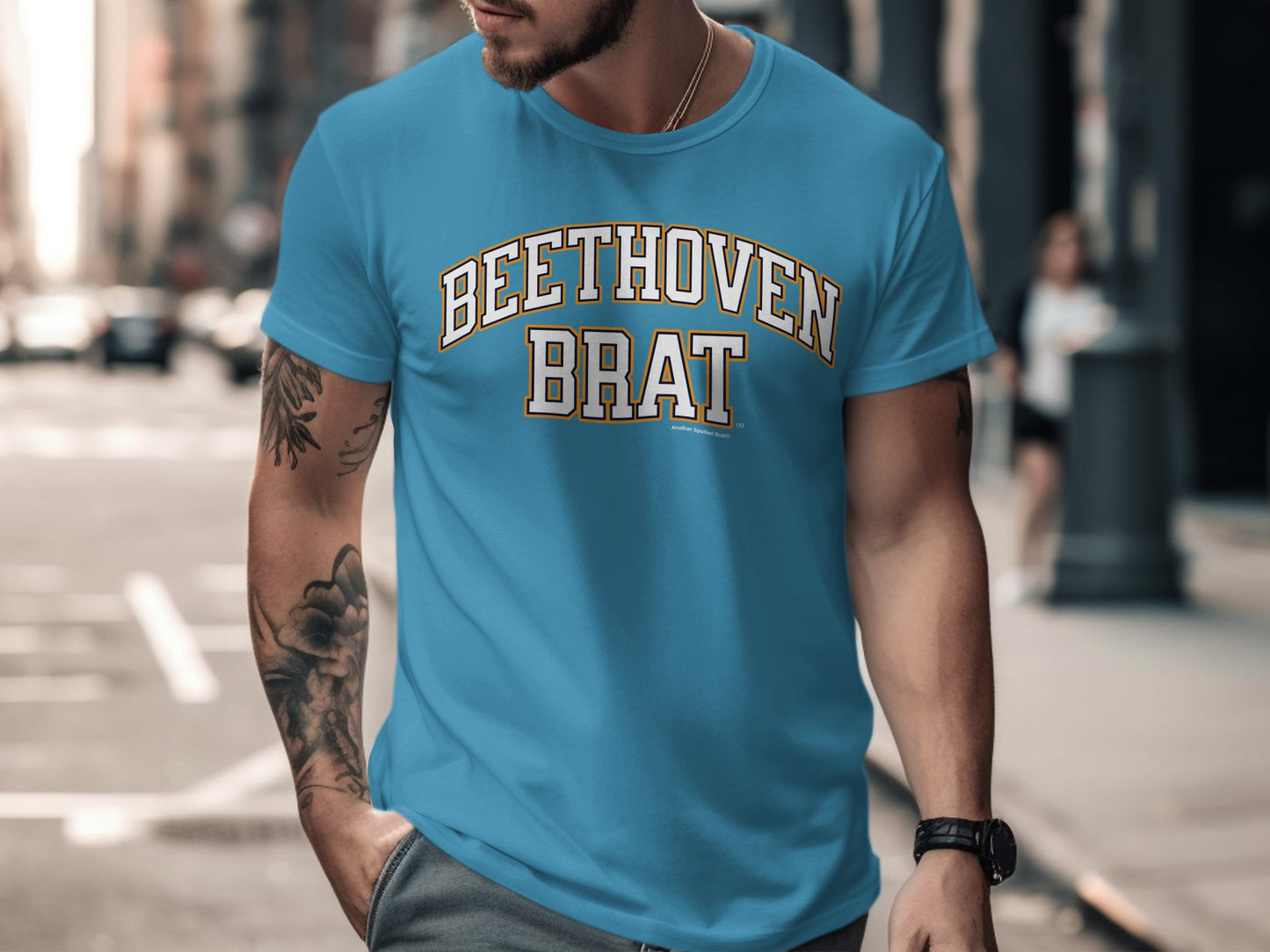 Turquoise t-shirt with "BEETHOVEN BRAT" text on chest, on a man.