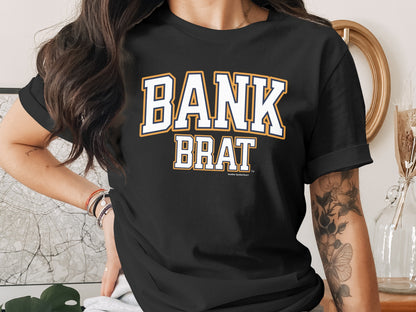 Black t-shirt with white and gold "BANK BRAT" graphic, "Another Spoiled Brat" below.