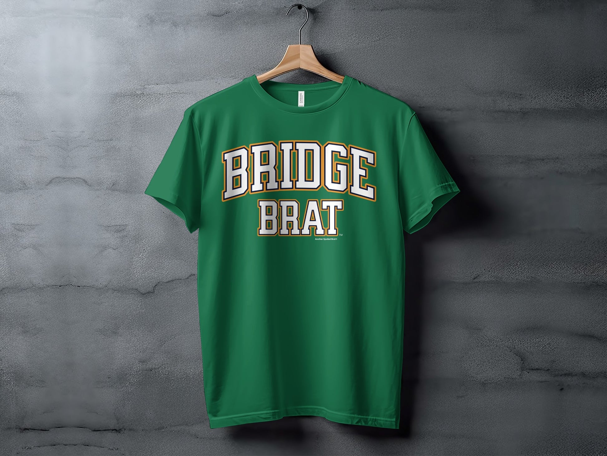 Green t-shirt with "Bridge Brat" text in white and gold lettering.