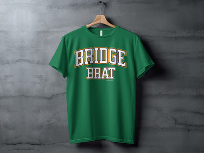 Green t-shirt with "Bridge Brat" text in white and gold lettering.