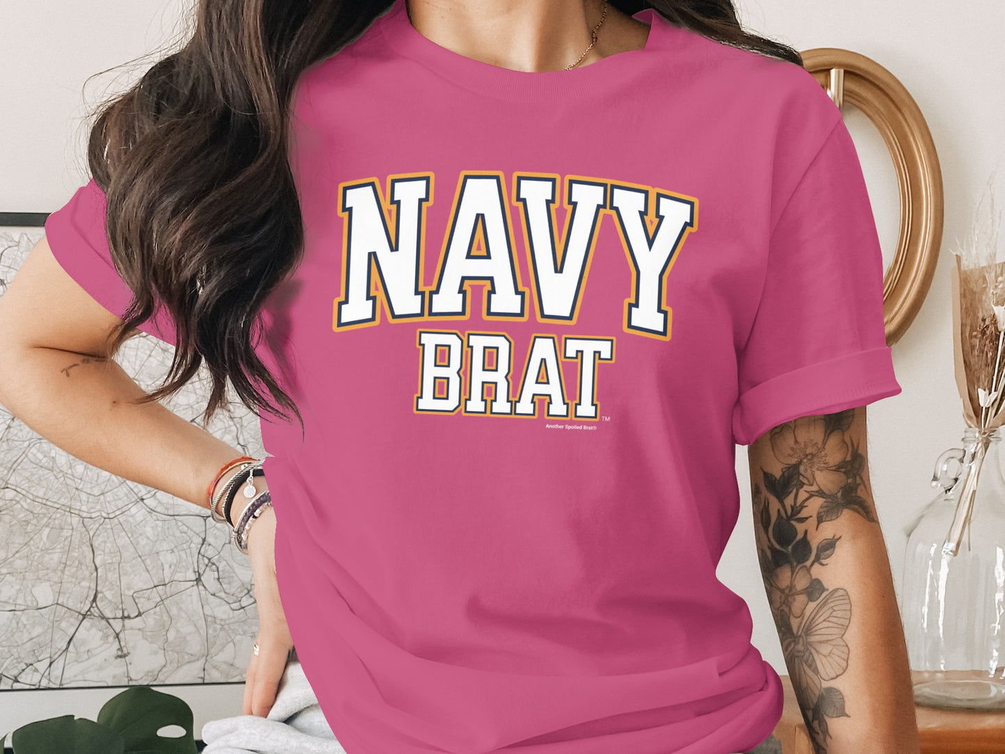 Pink t-shirt with "NAVY BRAT" text in collegiate lettering.