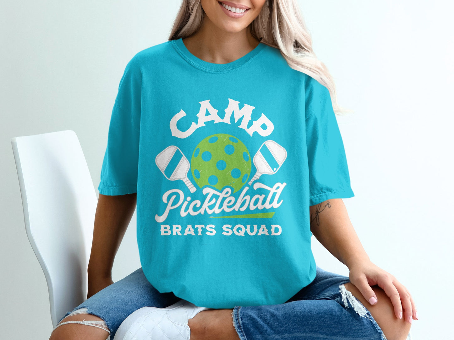 Turquoise t-shirt with "CAMP Pickleball BRATS SQUAD" and pickleball graphic.