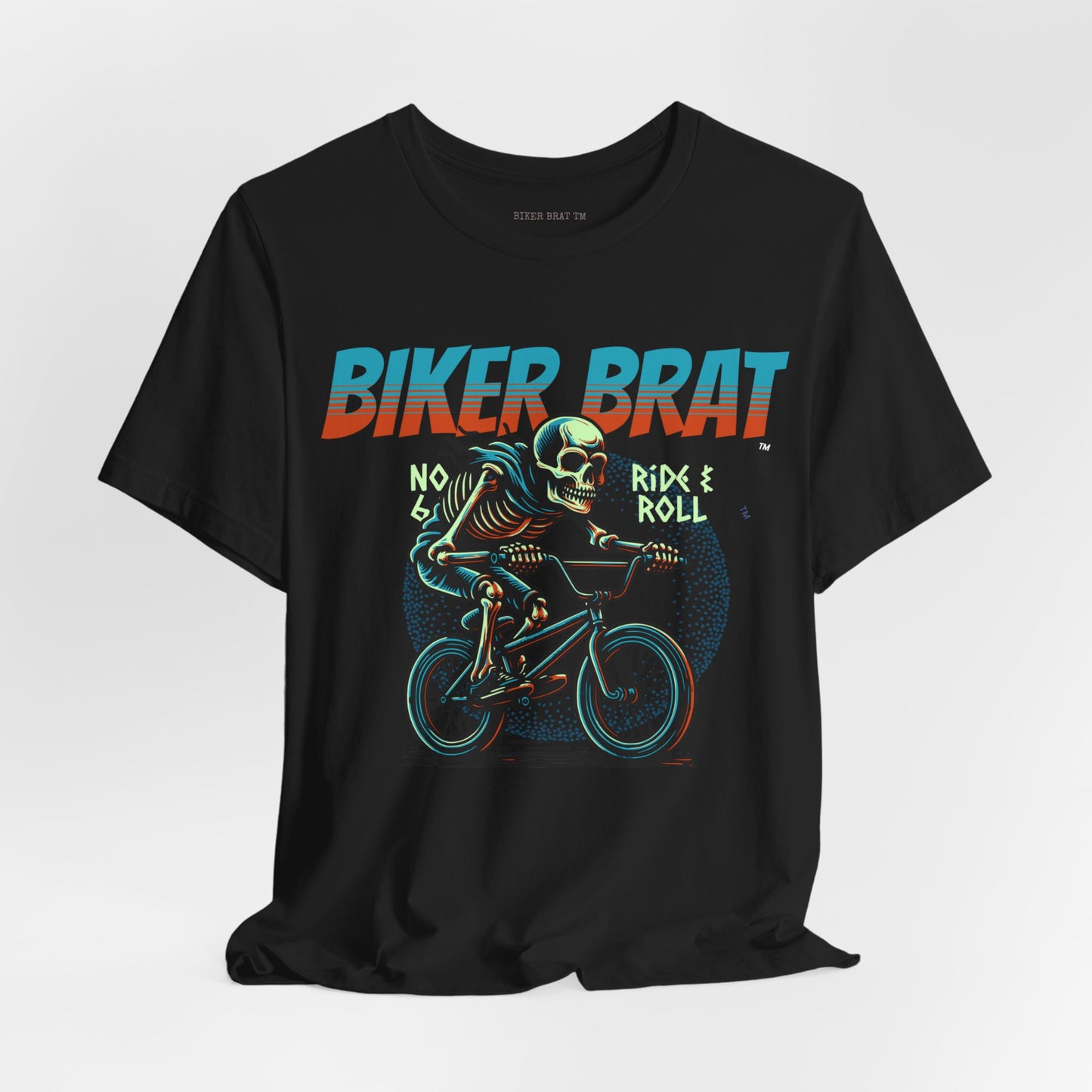 Skeleton on a BMX bike, "BIKER BRAT" text above, "RIDE & ROLL" text below.