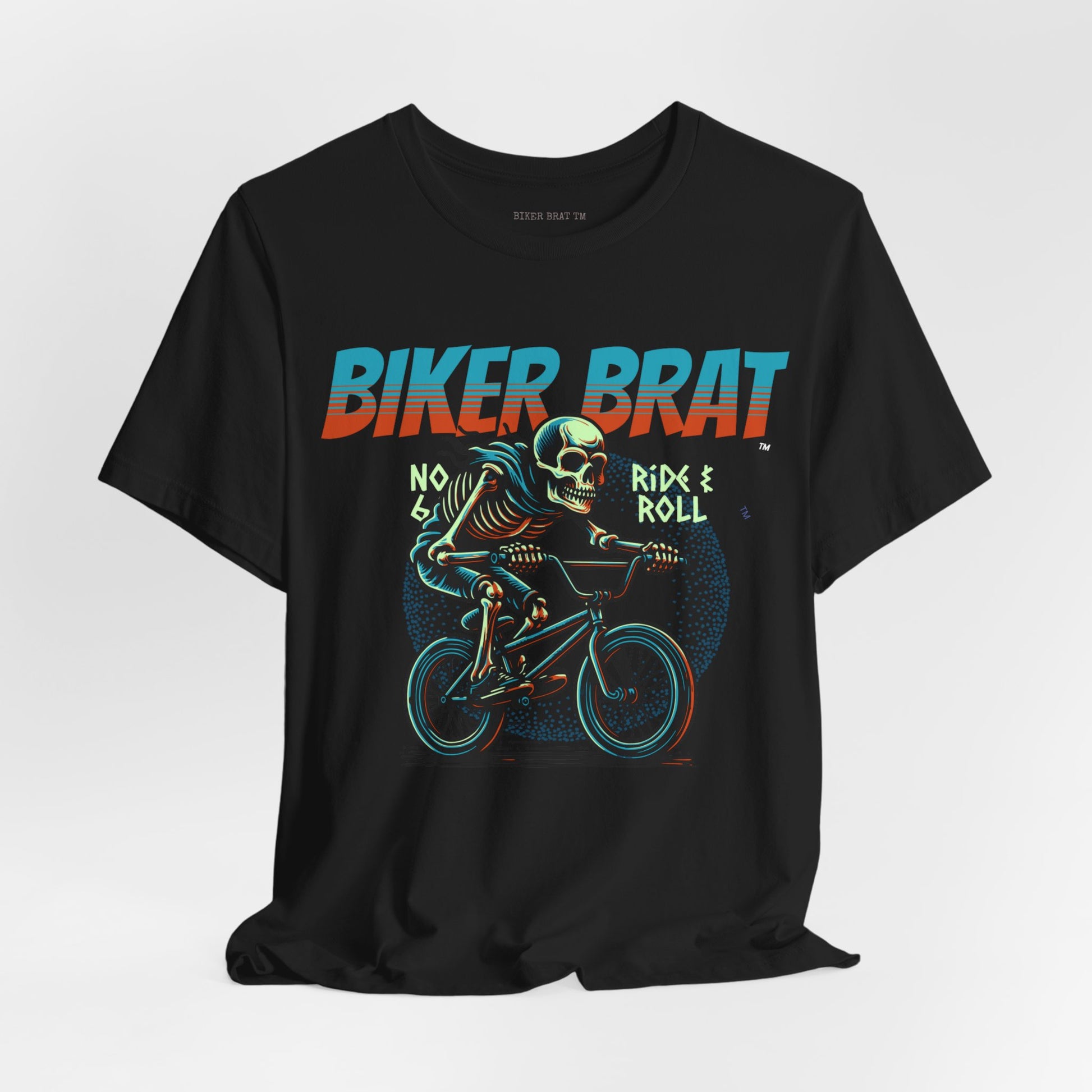 Skeleton on a BMX bike, "BIKER BRAT" text above, "RIDE & ROLL" text below.