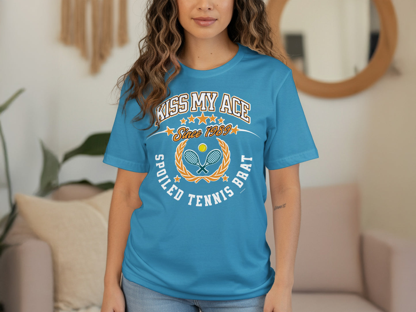 Blue t-shirt with "Kiss My Ace Spoiled Tennis Brat" text and tennis graphics.