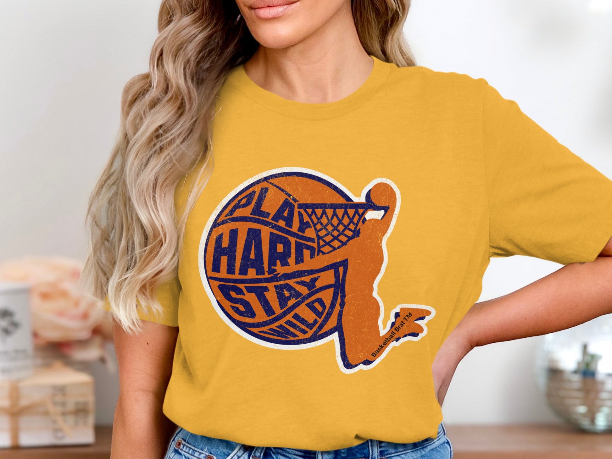 Yellow t-shirt with orange basketball player silhouette and "Play Hard Stay Wild" text.